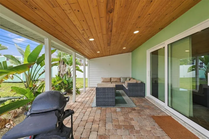 Backyard patio area with pavers and beautiful finished ceiling.