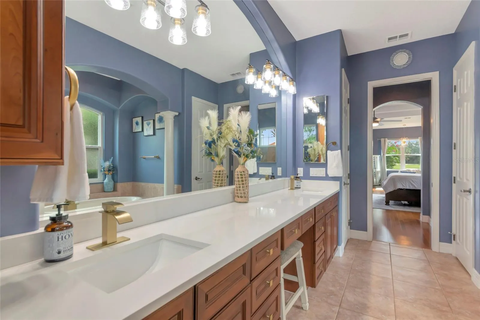 Primary bathroom wood cabinets, large shower and garden tub, light and bright with plenty of natural lighting