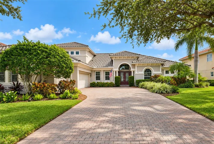Beautiful curb appeal, new roof, gutters and a long shady brick paver driveway