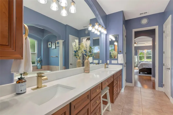 Primary bathroom wood cabinets, large shower and garden tub, light and bright with plenty of natural lighting
