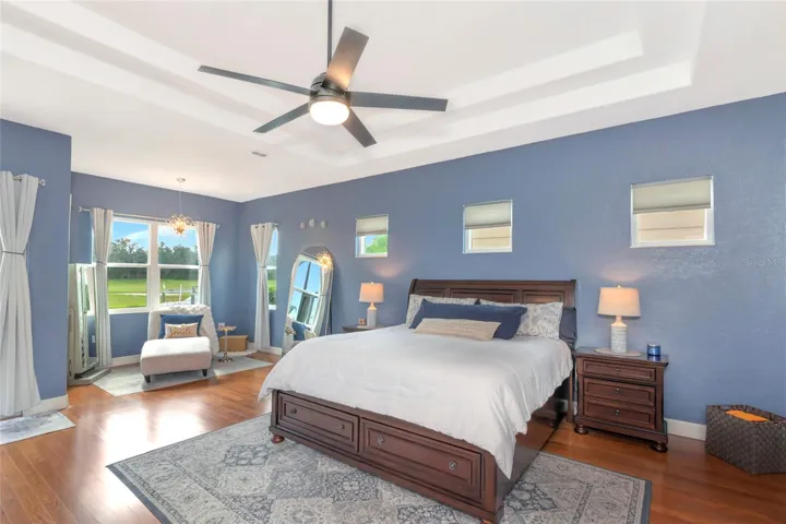 double tray ceiling, large primary bedroom with a sitting area, and plenty of natural light.