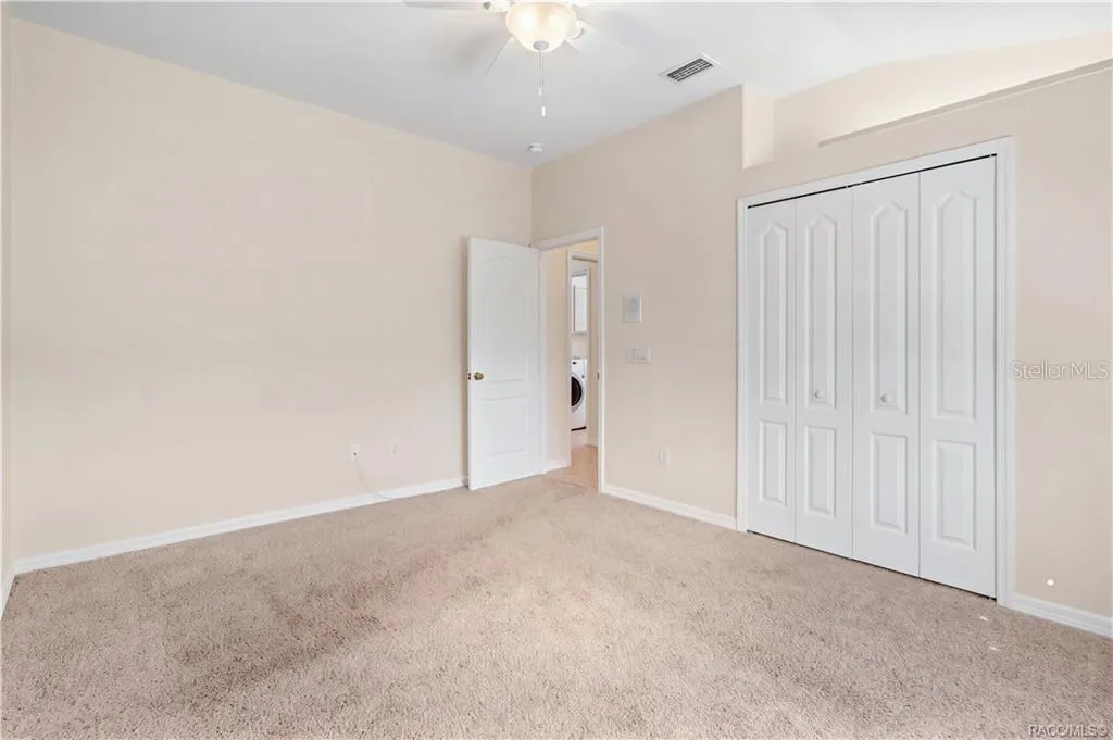BEDROOM 3 – Alternate view highlighting the double bi-fold closet doors, lighted plant shelf, ceiling fan.