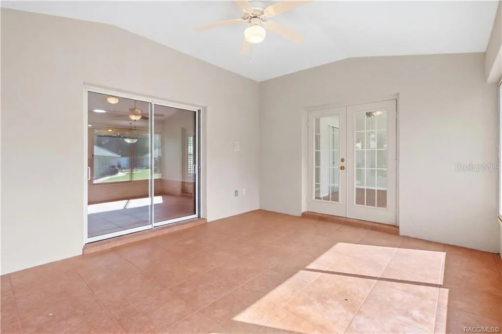 FLORIDA ROOM / BONUS LIVING SPACE – Bright tiled bonus space ceiling fan, French doors entering FLEX /4th Bedroom &amp; sliding-glass doors connecting to the living room.