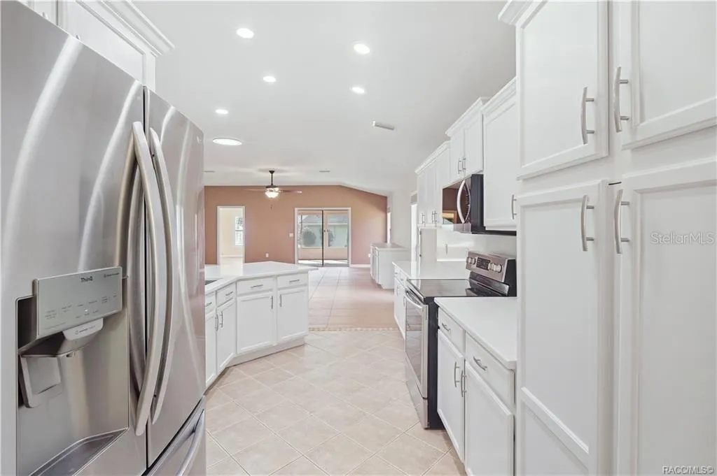 KITCHEN STORAGE &amp; WORKSPACE – Excellent cabinet storage surrounds the kitchen, complemented by stainless-steel appliances, quartz countertops &amp; generous workspace. The open configuration keeps the kitchen connected to the great room instead of tucked away.