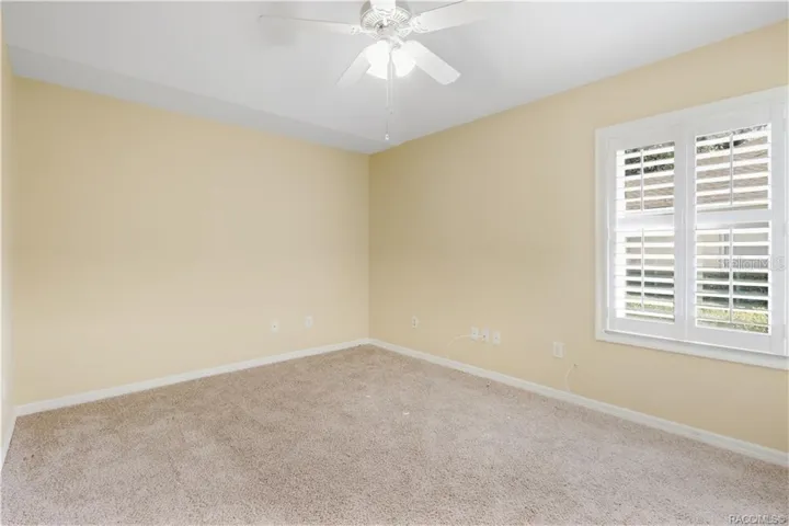 BEDROOM 2 – Guest bedroom featuring ceiling fan &amp; window with plantation shutters.