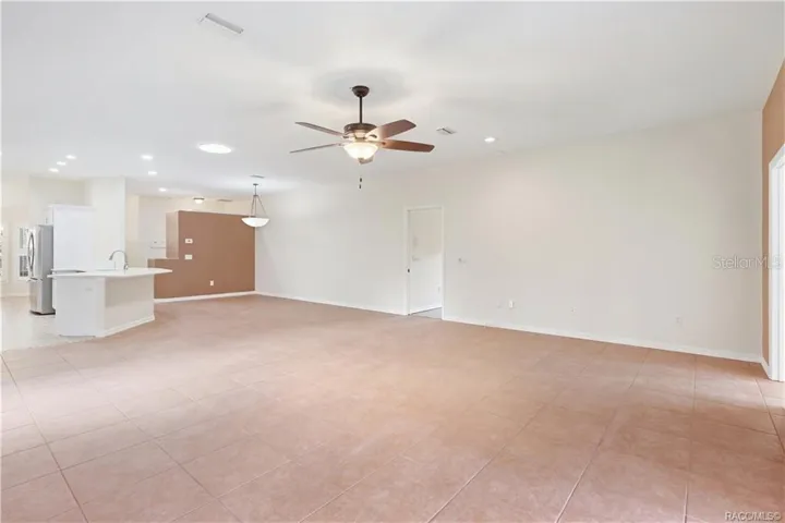 Living Room TO KITCHEN – Spacious main living area flows directly into the kitchen &amp; dining spaces, making the layout especially functional for everyday living or entertaining. Tile flooring continues throughout for a cohesive look.