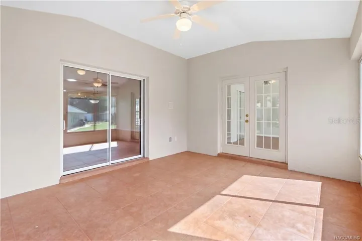 FLORIDA ROOM / BONUS LIVING SPACE – Bright tiled bonus space ceiling fan, French doors entering FLEX /4th Bedroom &amp; sliding-glass doors connecting to the living room.