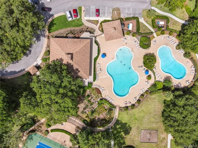 COMMUNITY POOLS &amp; CLUBHOUSE – Aerial view showcasing Meadowcrest’s recreational complex featuring two community swimming pools, clubhouse &amp; spacious poolside areas surrounded by mature landscaping.