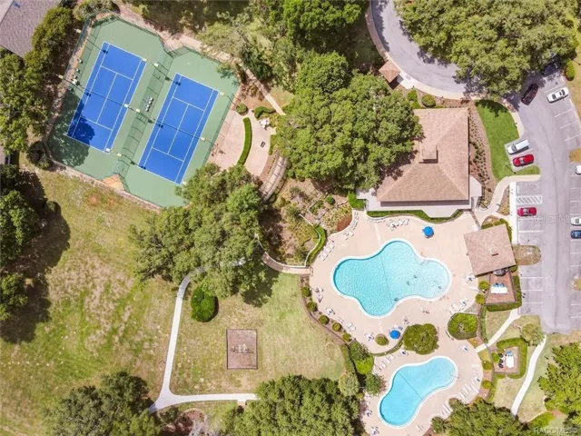 MEADOWCREST AMENITIES – Aerial view highlighting Meadowcrest’s recreation area with two swimming pools, clubhouse, lighted tennis/pickleball courts &amp; beautifully maintained outdoor gathering spaces.