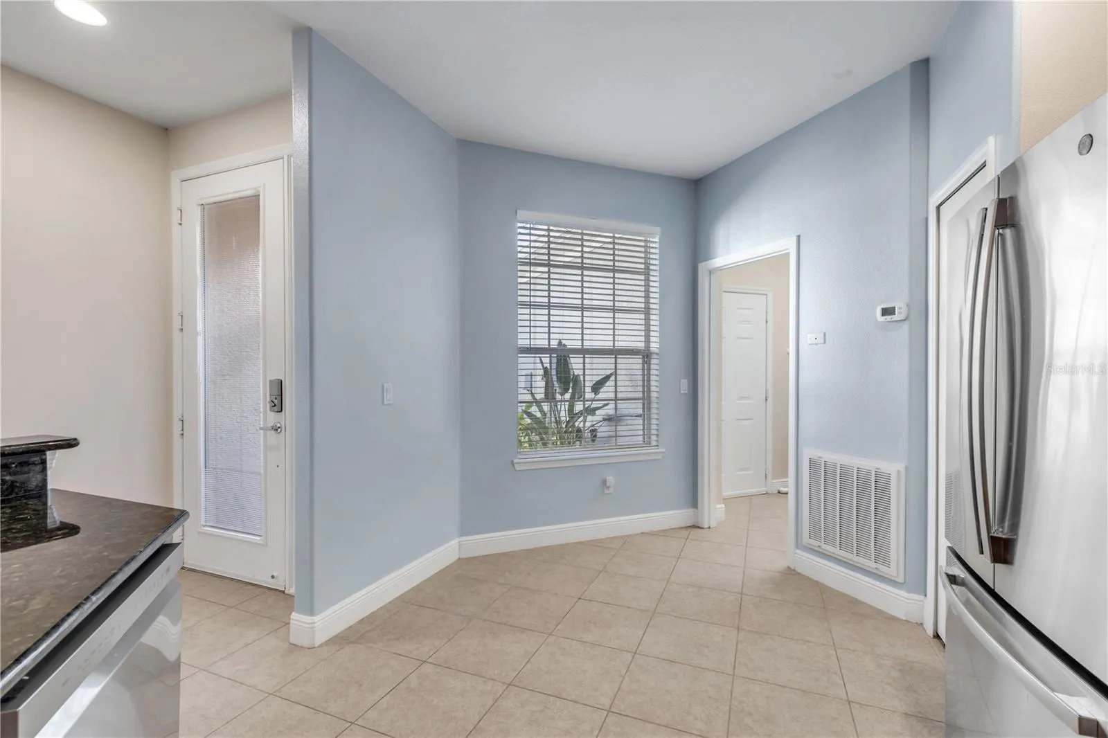front door entry way leading into the kitchen, further into the laundry and garage