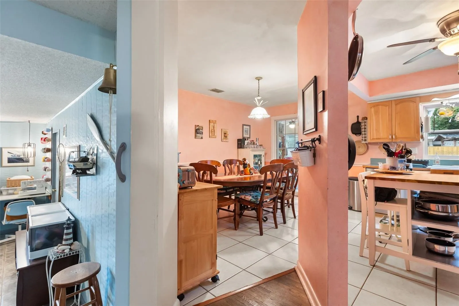 Bonus room, dining room, and kitchen.  Off to the right is the hallway to the downstairs bedrooms.  Behind photographer is the downstairs living room.
