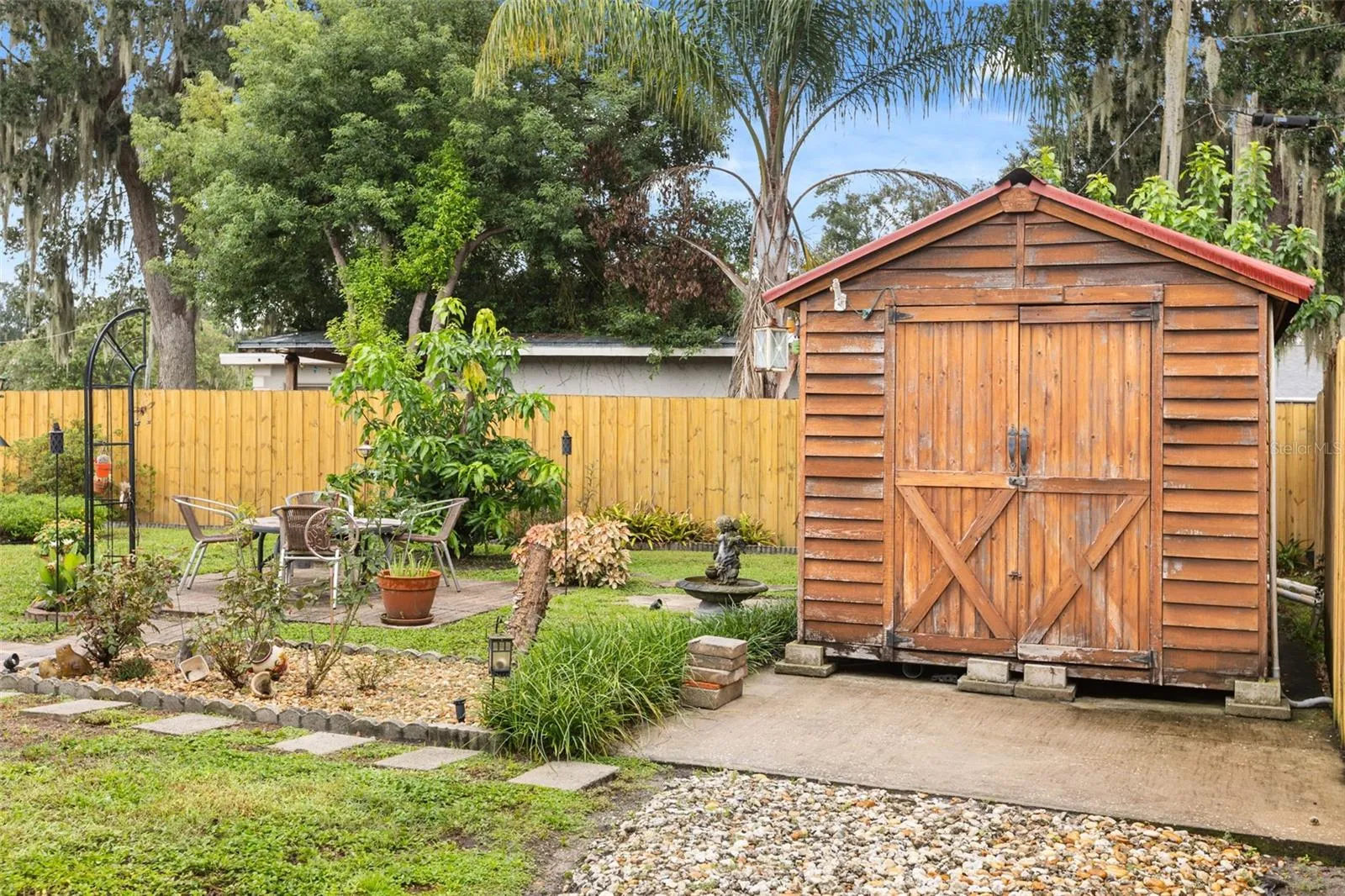 Fire pit, fruit tree, and shed.