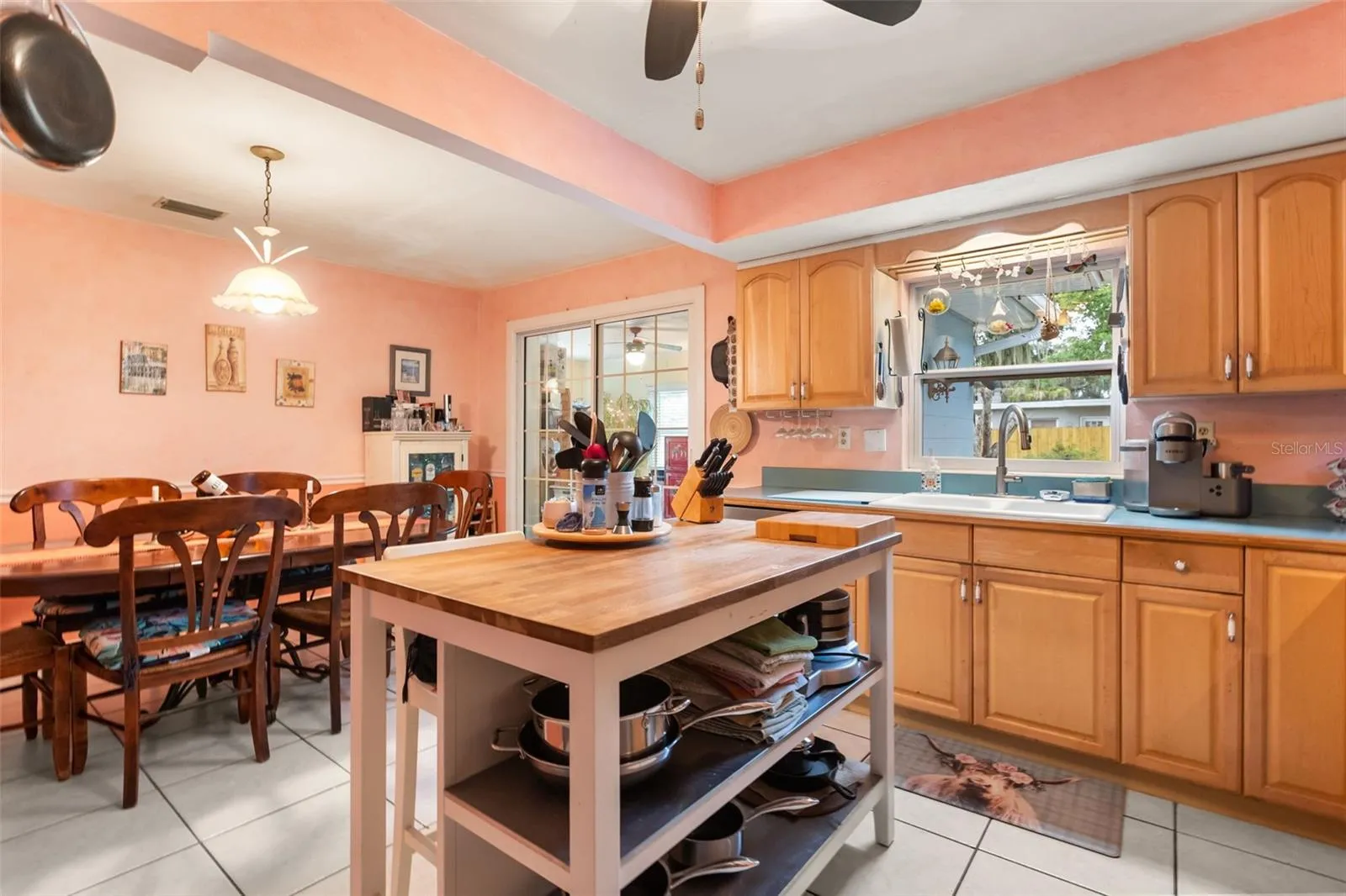 Kitchen, dining room, and sliding glass door to one of the bonus rooms.