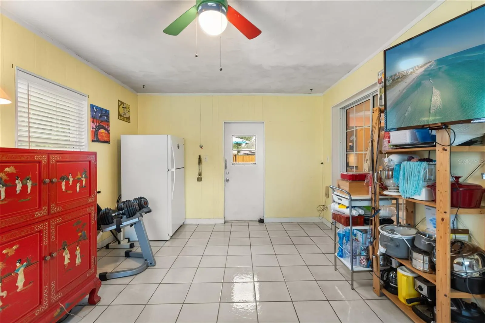 Bonus room with door to backyard straight ahead and sliding glass door to the right leads to the dining room.
