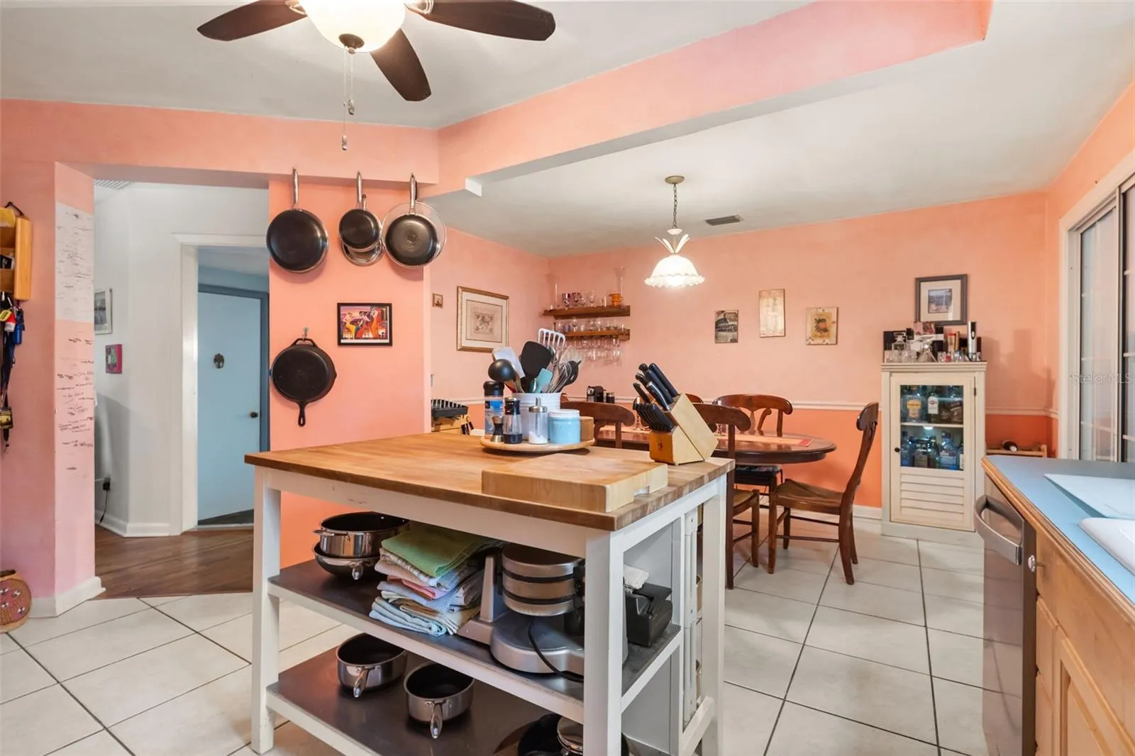 Kitchen is open to the dining room.  The doorway leads to a bonus room. The far door leads to the upstairs.