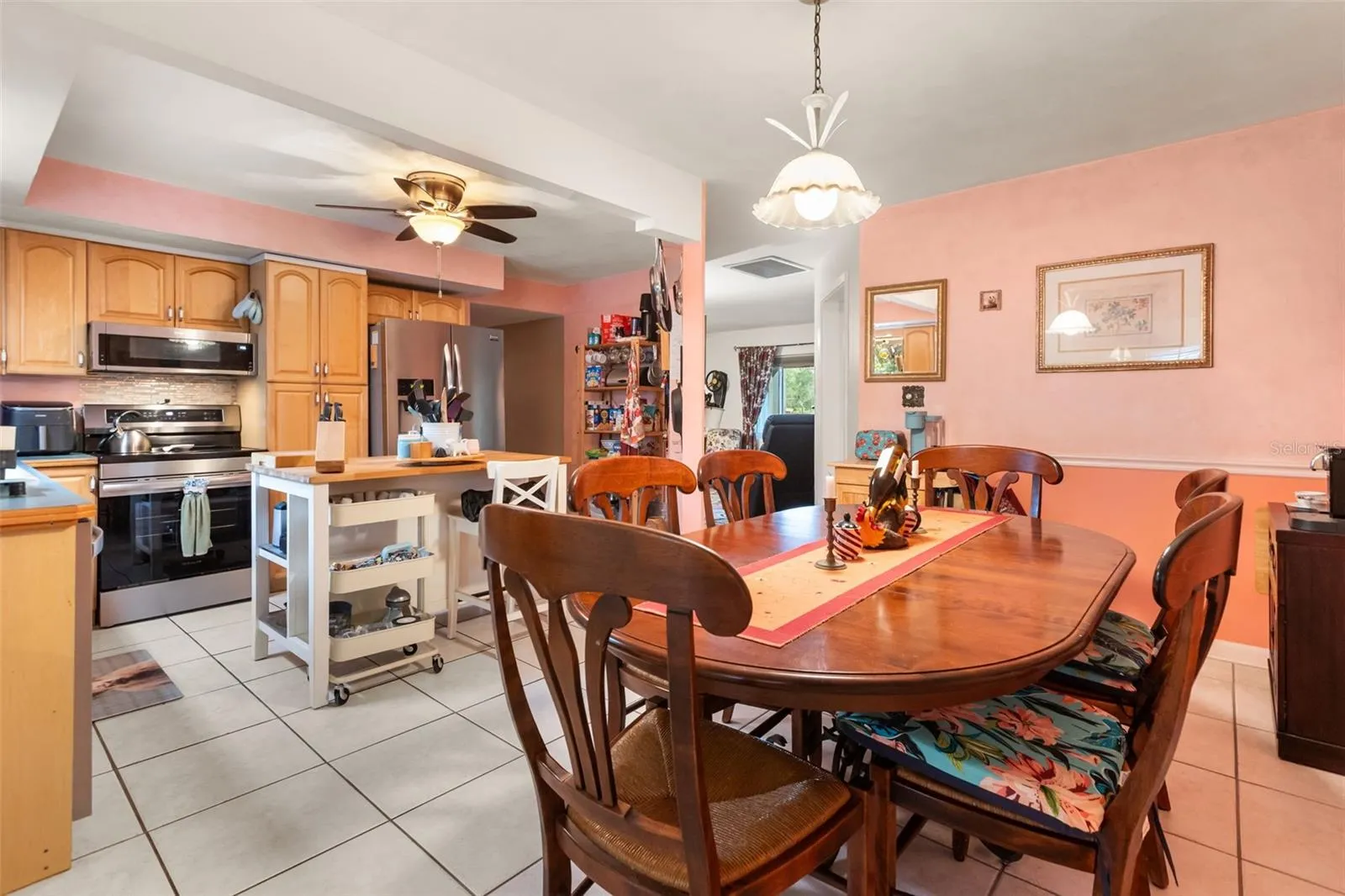 Dining room and kitchen are open to one another.  Far doorway to right is to living room, far doorway to the left is to bedroom hallway.  One bonus room is behind photographer.