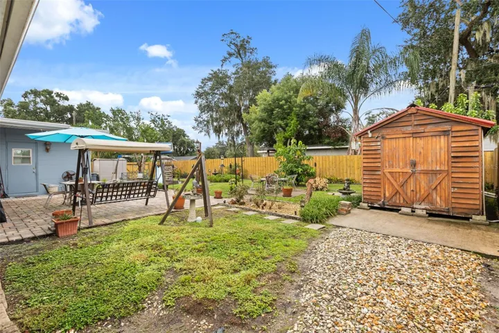 Pavered patio, beautiful landscaping, and shed.