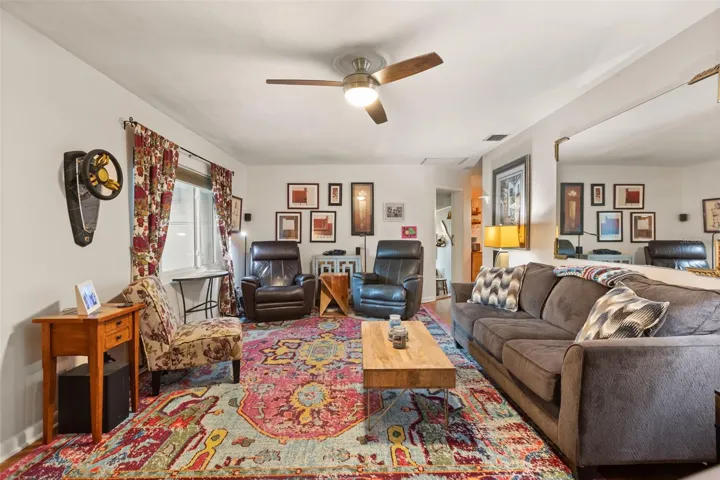 The front door is to the left, hallway to bedrooms behind photographer.  Doors at far right lead to a bonus room (left) and dining room and kitchen (right).