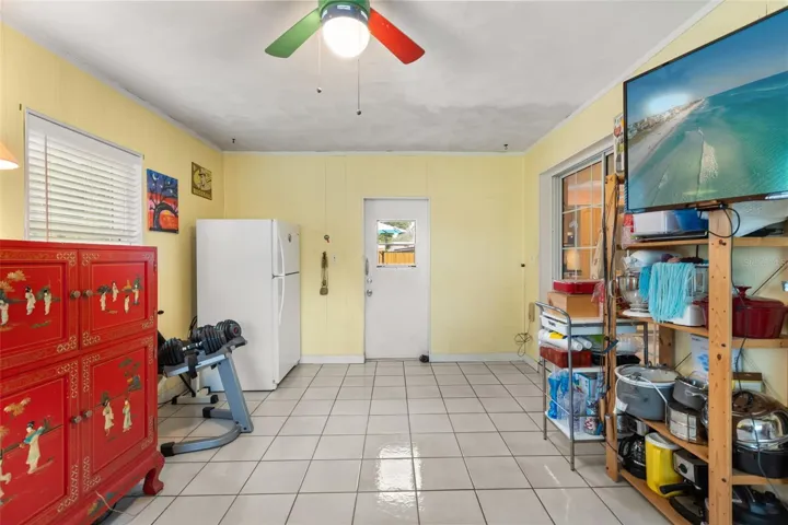 Bonus room with door to backyard straight ahead and sliding glass door to the right leads to the dining room.