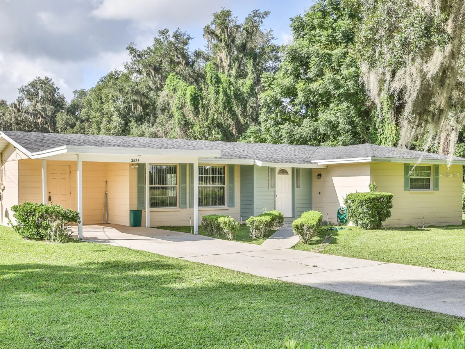 Front of the home with a one car carport.