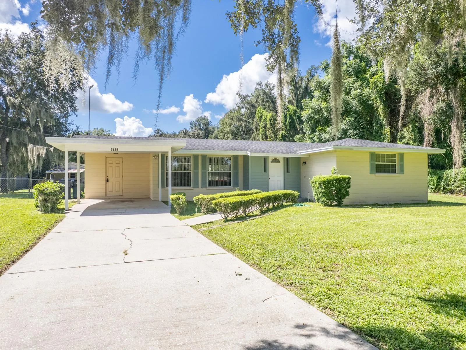 Front of the home with a one car carport.
