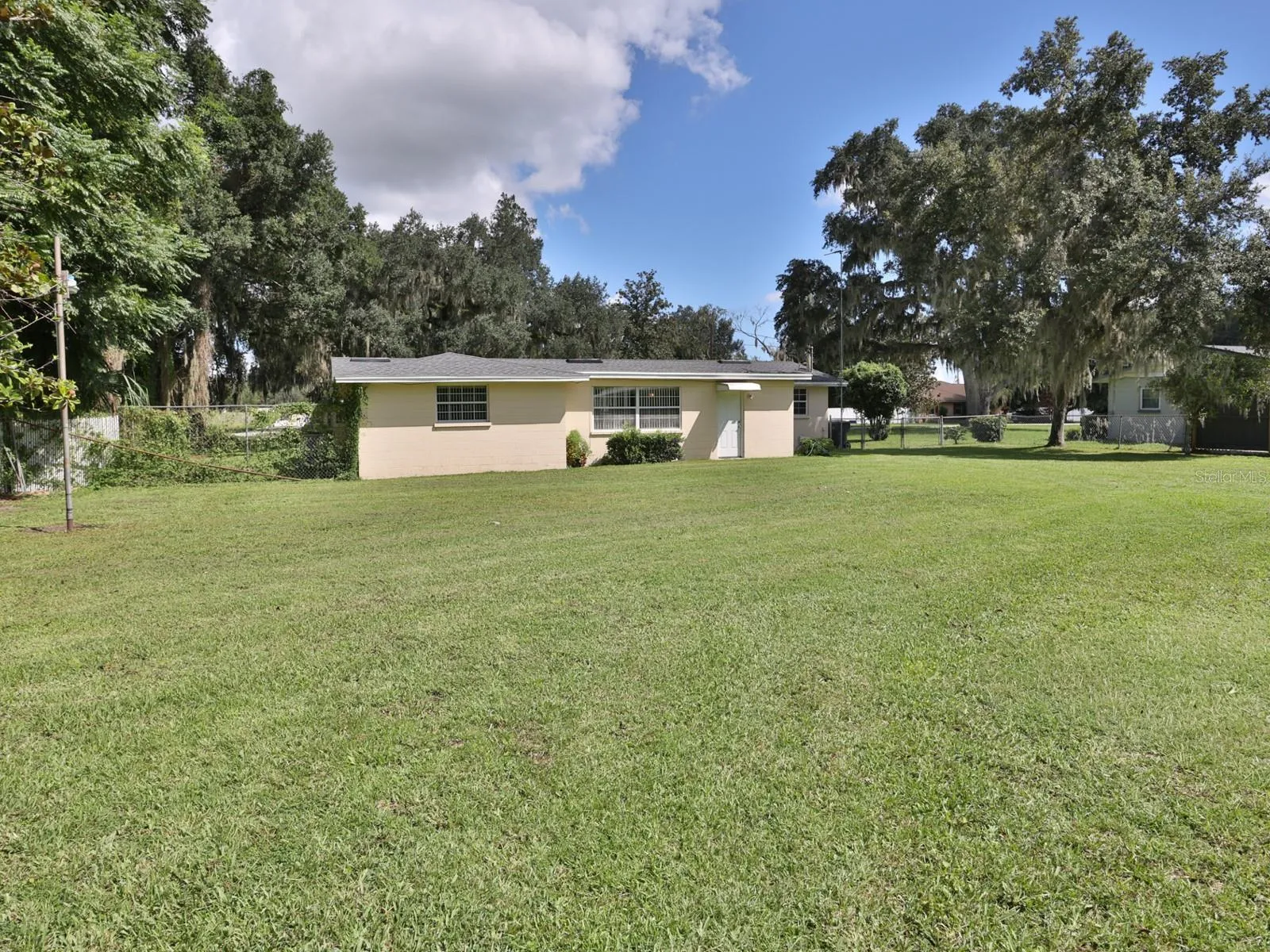 Large yard with view of the home.