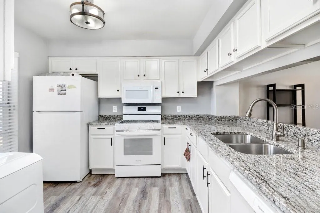 kitchen with new Cabinet, granite countertops and beautiful wood plank tile floors