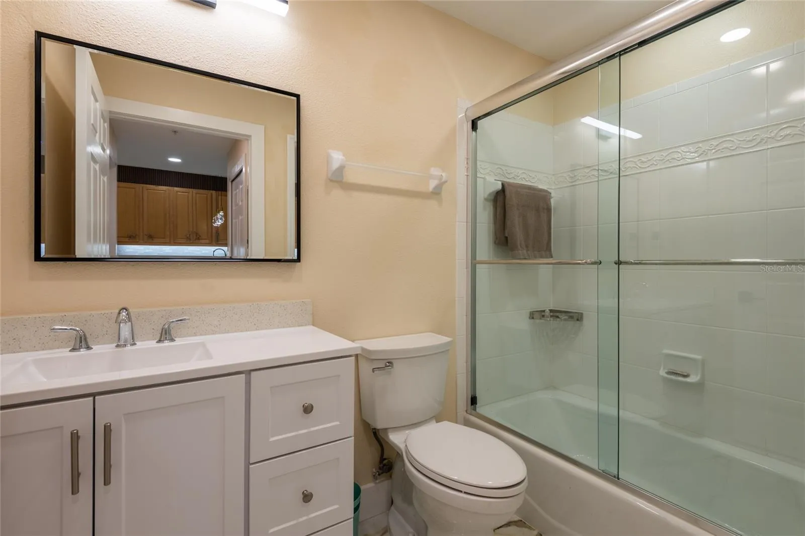Guest (2nd bathroom) with custom glass shower doors and heated floors.