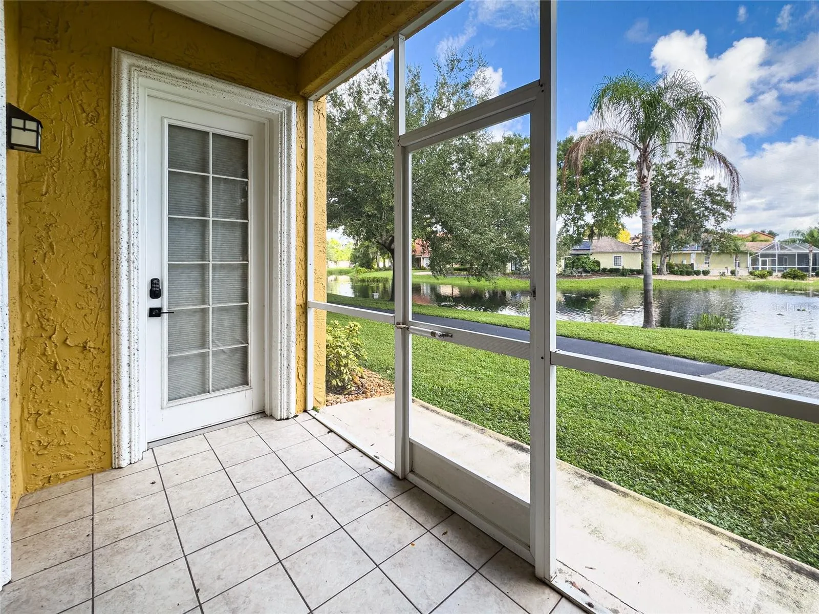Tiled covered and screen lanai looking out at the lake.  Private Master bedroom door to lanai, plus LR sliding glass doors.