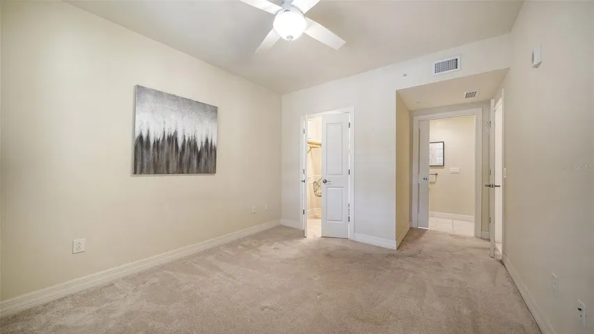 Walk-in closet with the door to the 2nd bathroom