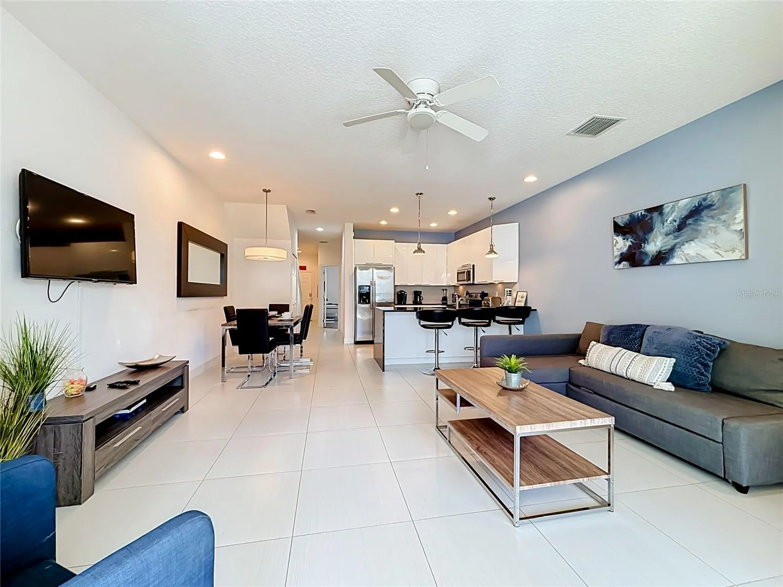 Living / Dining / Kitchen — Wide-open main living area showcases the home's flowing floor plan from the living room through the dining area and kitchen.