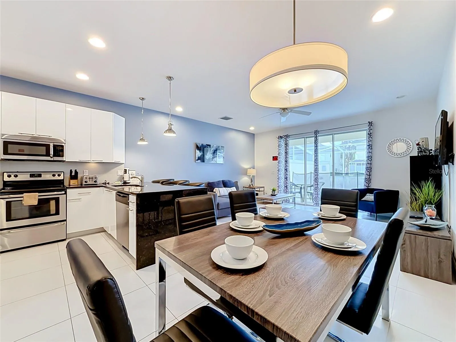 Dining / Kitchen — Open-concept dining area flows seamlessly into the kitchen and main living space, ideal for entertaining and vacation stays.