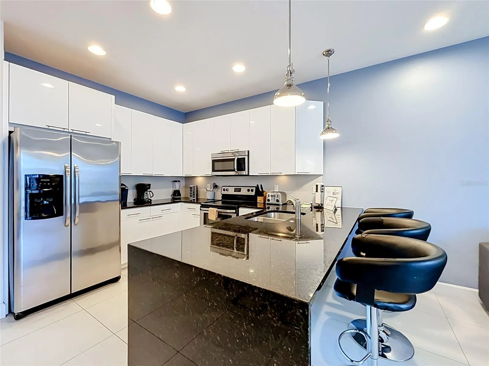 Kitchen / Breakfast Bar — Large kitchen peninsula provides additional prep space and casual bar seating for three.