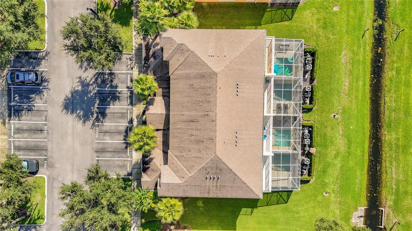 Aerial View — Aerial view highlights the home's position along the pond, offering a more open setting with no townhomes immediately behind.