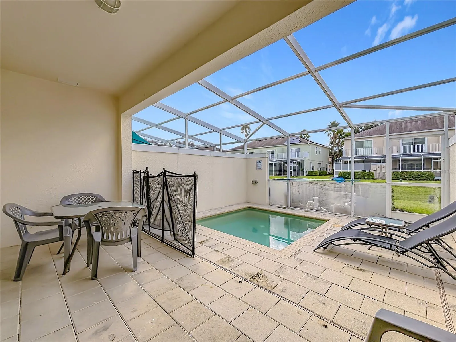 Private Pool &amp; Patio — Step outside to your private screened pool and patio, with space for outdoor dining and relaxing in the Florida sunshine.