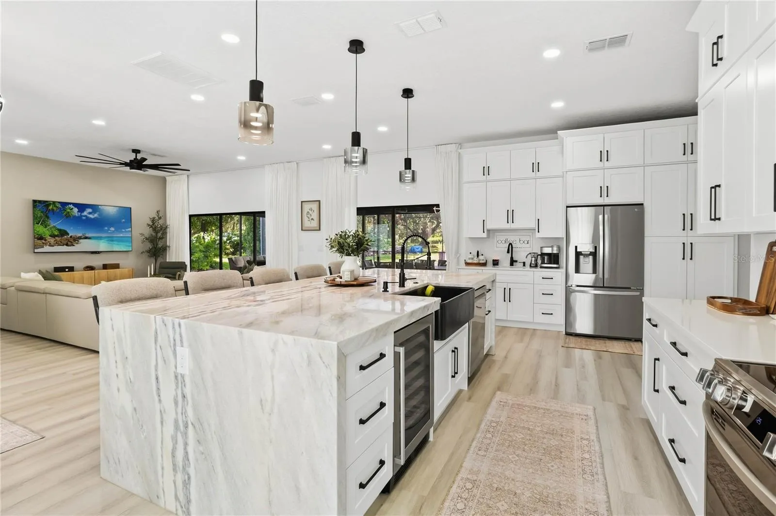 Kitchen Island with waterfall countertop, Wet Bar with 2nd sink to the left of the refigerator