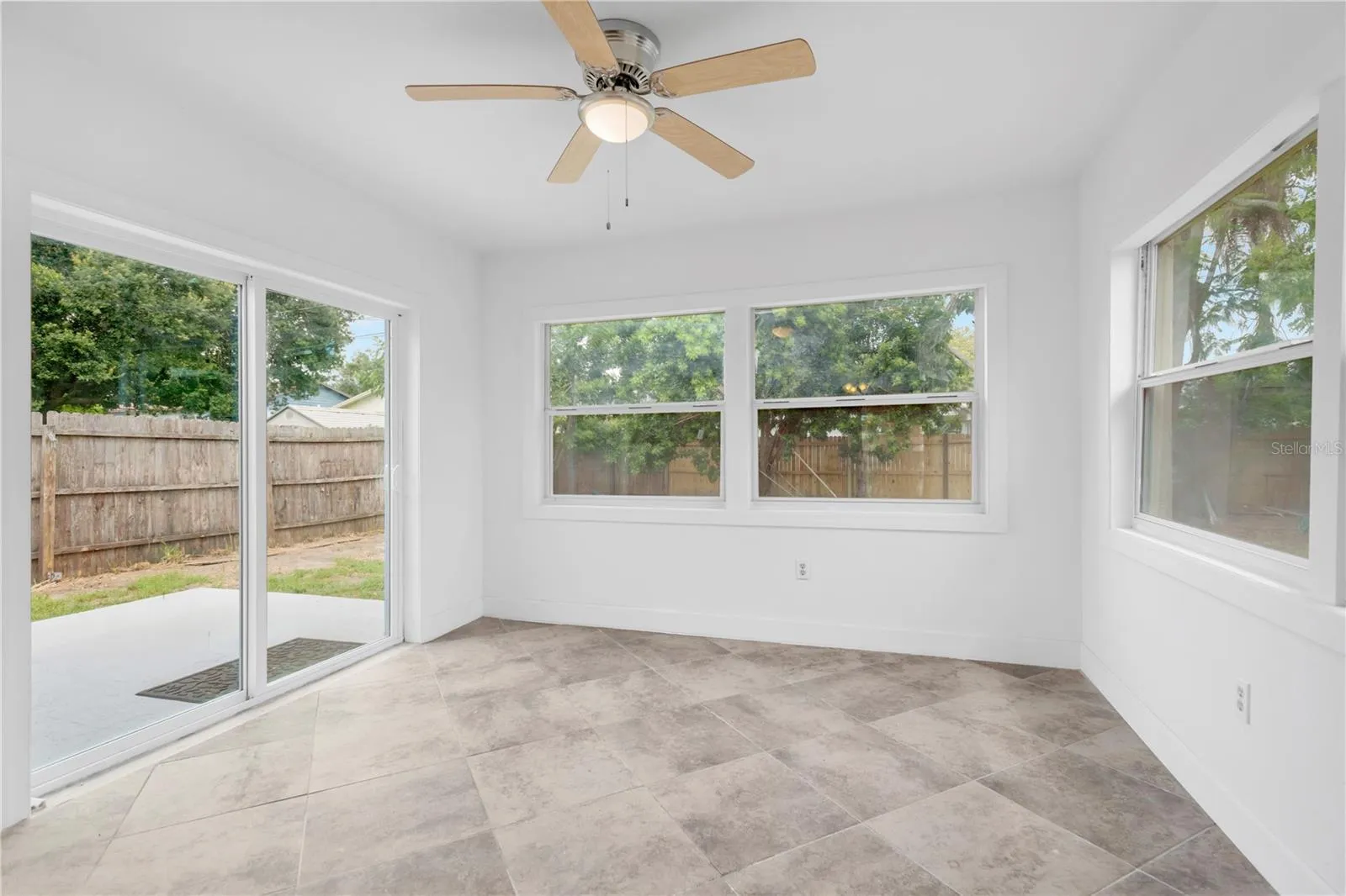 Just off the kitchen is a bonus room with lots of windows and a new sliding glass door to the backyard.