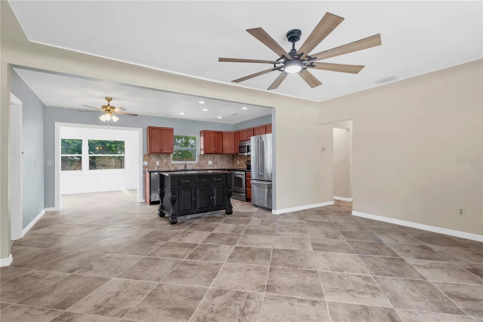Featuring durable large-format tile flooring laid on the diagonal and abundant natural light.