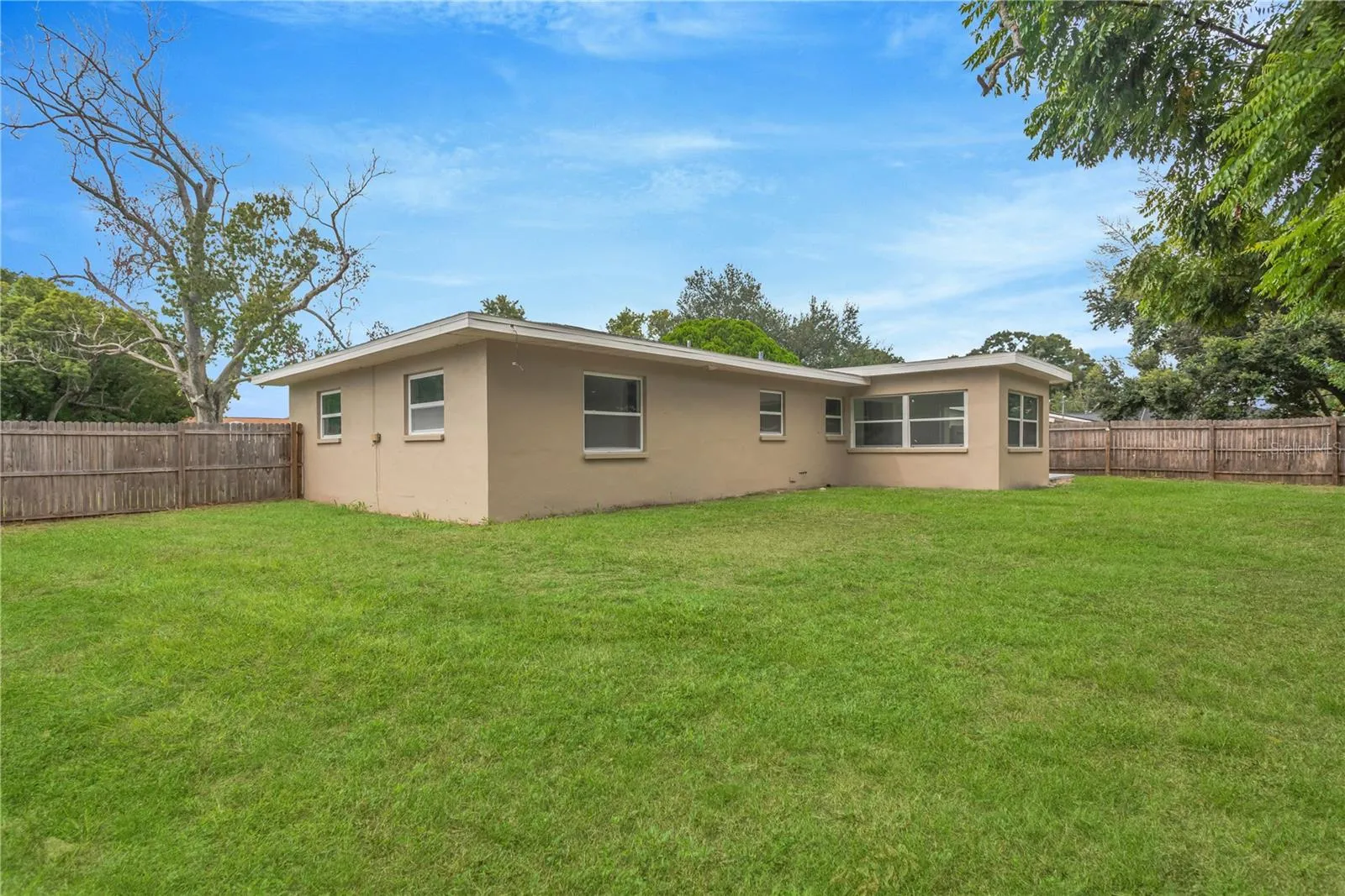 The backyard is a blank canvas, ready for a new owner to create their own private oasis and outdoor retreat.