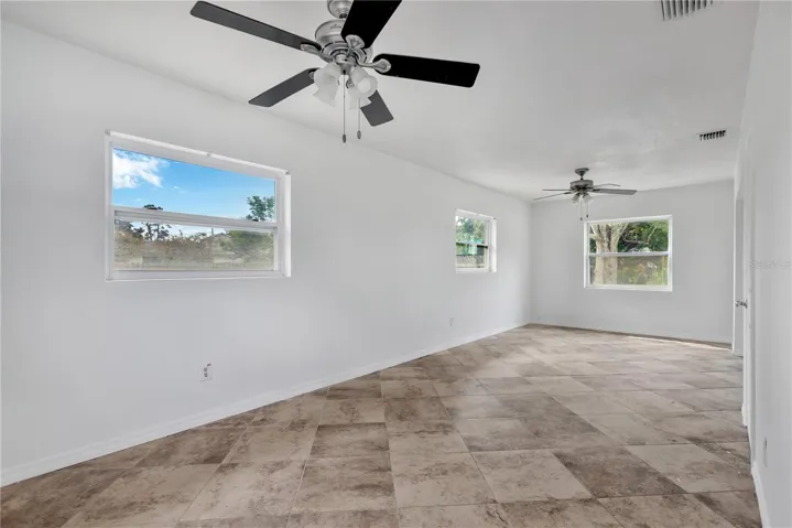 The spacious Primary Bedroom features plenty of windows for natural light, ample room for furnishings, and a beautifully remodeled ensuite bath.