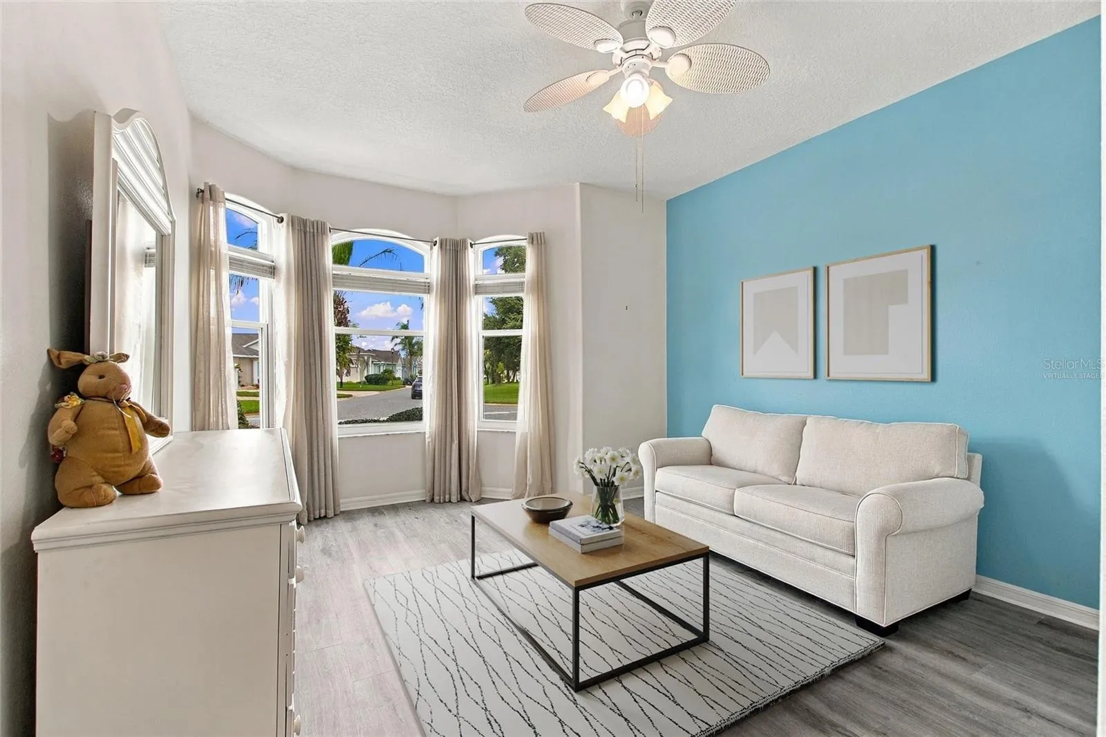 Virtually staged rug, table and 2 wall art in front guest room