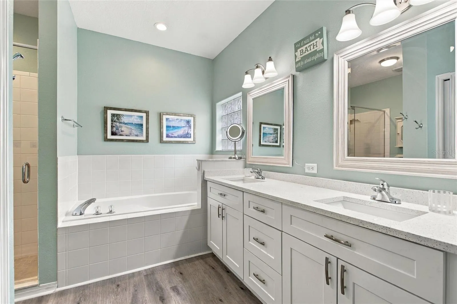 Primary bathroom with updated dual vanity &amp; shower