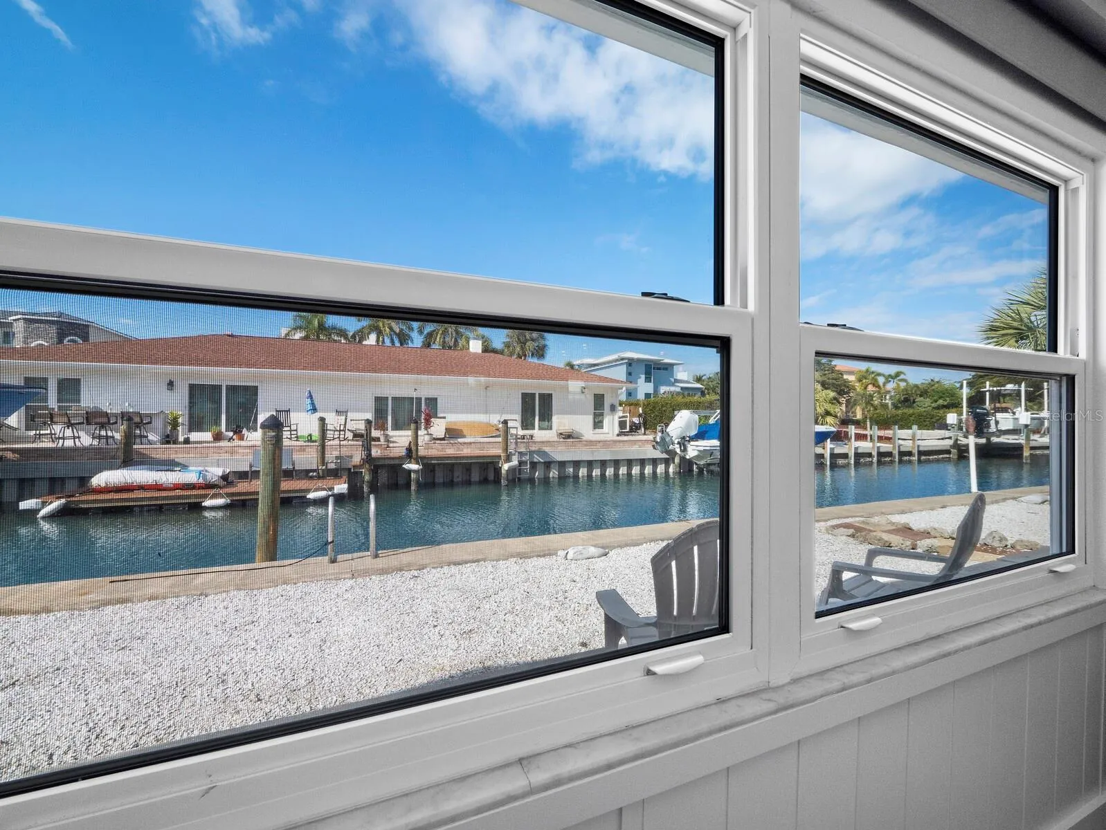 Storm rated windows across the entire room offer beautiful natural light and a view to the canal