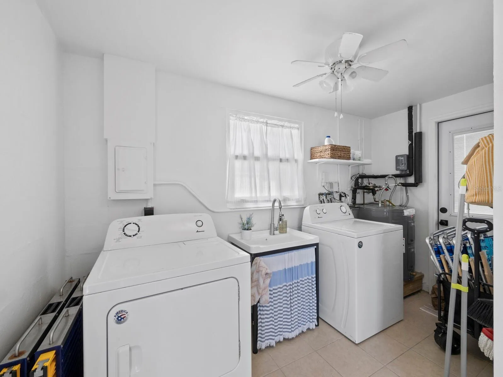 Part of the 2nd bathroom where the sink and the laundry reside. Great for additional storage and easy access to the separate water closet and shower.