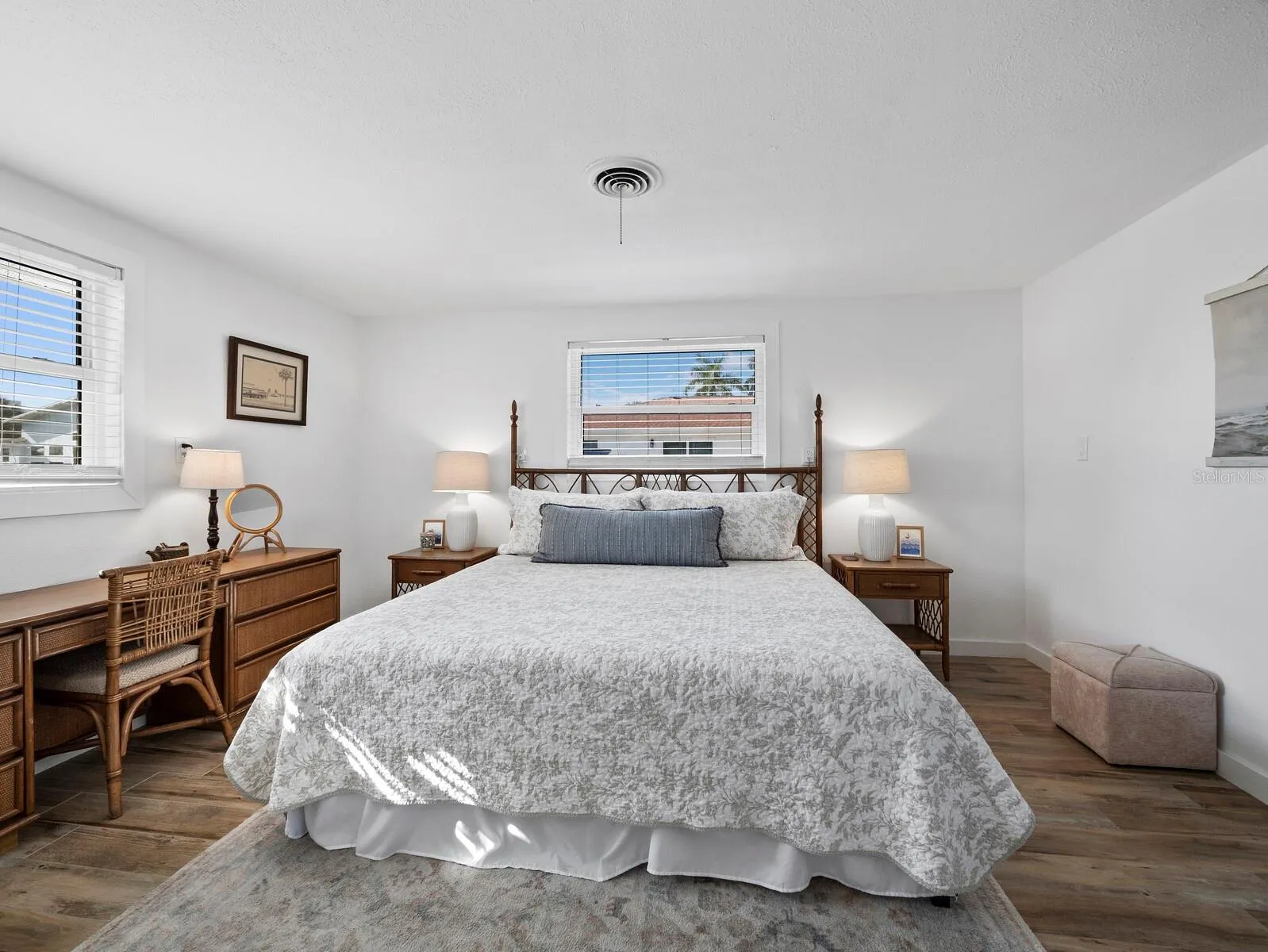 The primary bedroom has a view to the canal and also to the large side yard