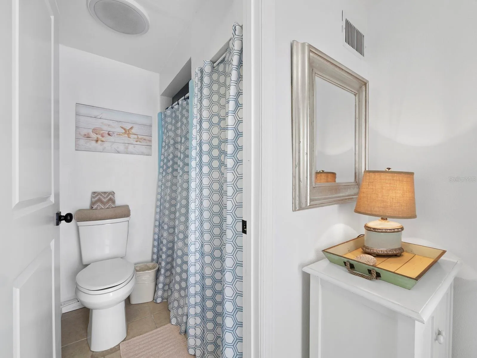 The 2nd bathroom offers a private water closet and shower with a separate sink area and a door to the back, making it perfect for coming in off the boat or if you put in a pool, there's easy acces.