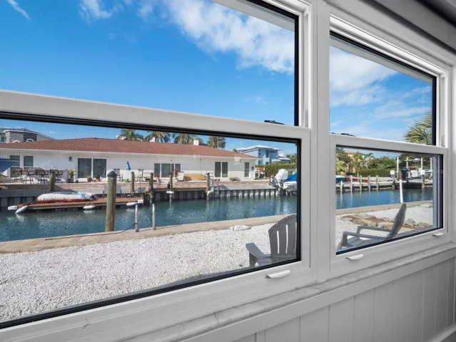 Storm rated windows across the entire room offer beautiful natural light and a view to the canal