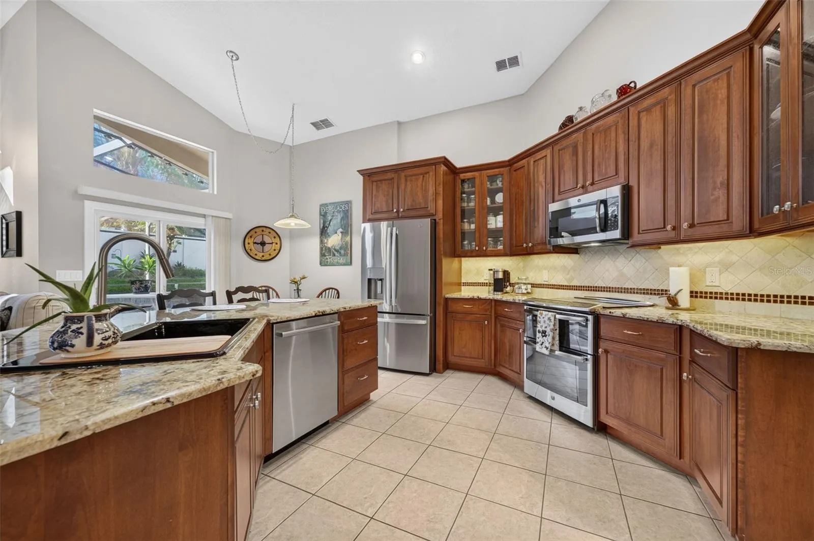 Gorgeous Remodeled Kitchen with Granite and Newer Stainless Steel appliances, Stone backsplash.