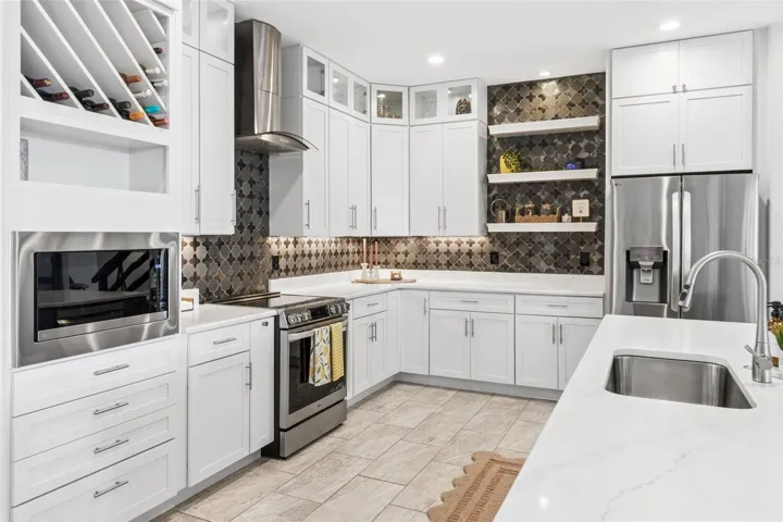 Stainless steel appliances include brand new refrigerator and microwave