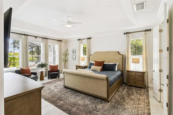 First floor primary bedroom opens to the pool and lanai